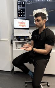 Dentist showing dentures and how to fix it